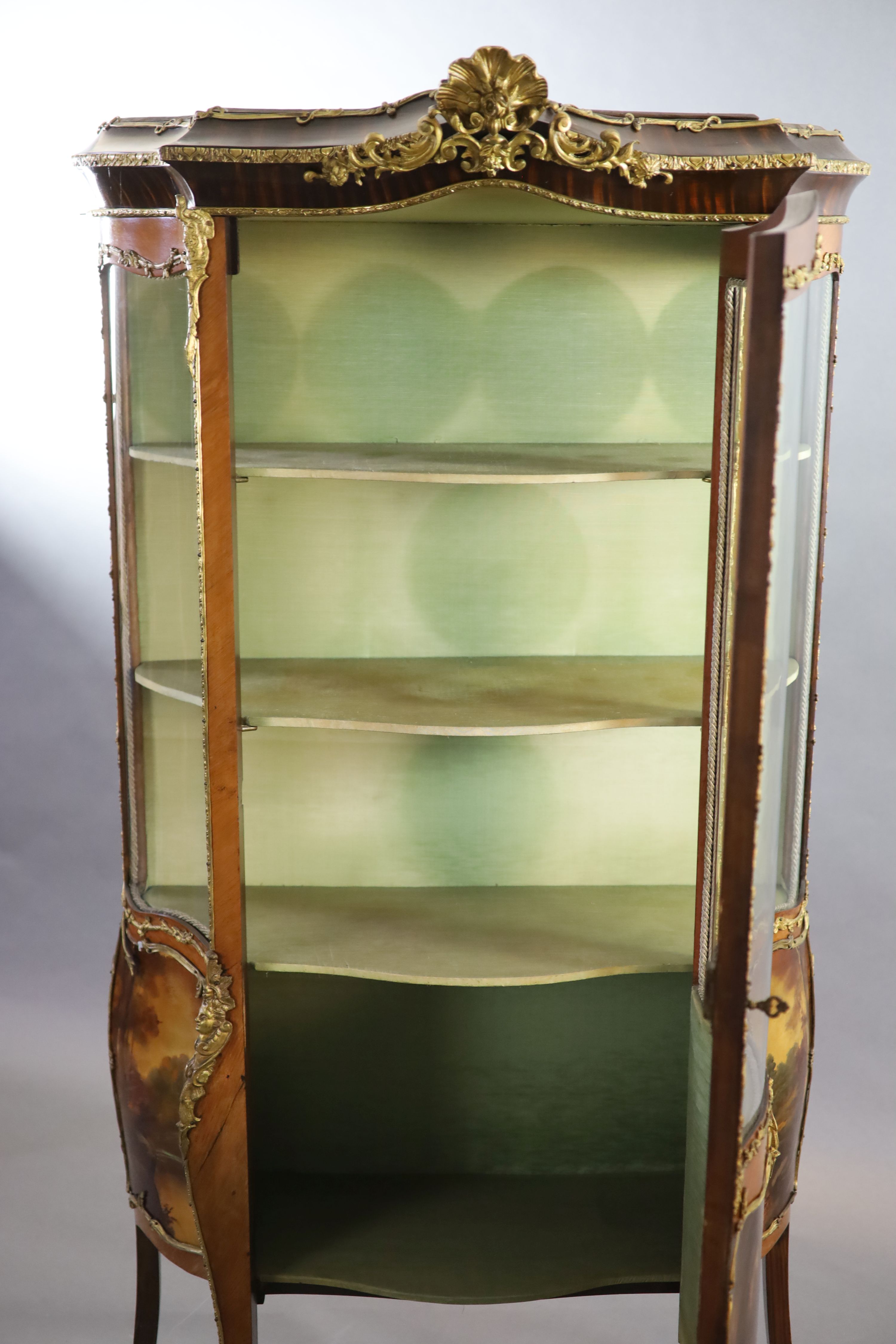 A Louis XV style mahogany vitrine, 76cm wide, 38cm deep, 194cm high.